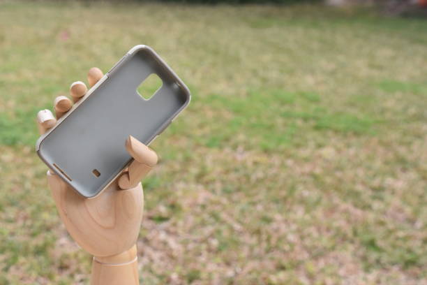 istock prosthetic hand holds cover for the cellphone 876466768