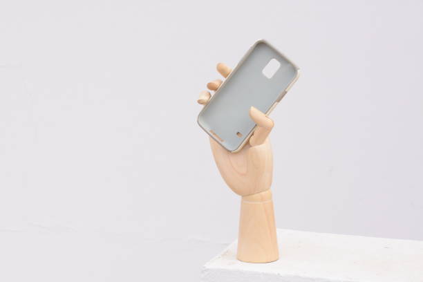 istock prosthetic hand holds cover for the cellphone 876467222