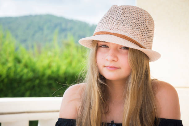 istock Girl with hat posing on a terrace 876467734