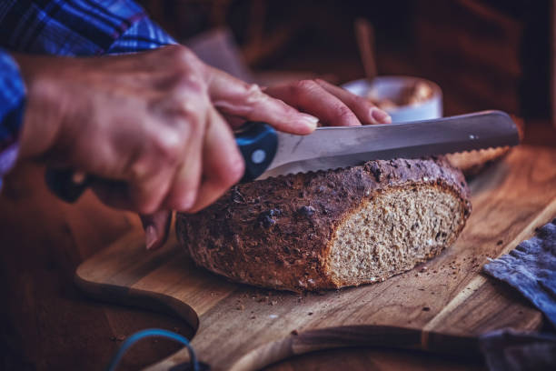 istock Cutting Fresh Homemade Brown Bread 876470846