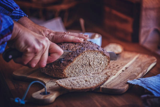 istock Cutting Fresh Homemade Brown Bread 876470858