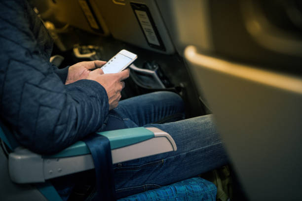 istock Man hand holding smartphone on board for chat and planning the trip 876474036