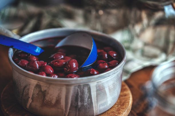 istock Preparing Homemade Cherry Compote and Canning in Jars 876474374