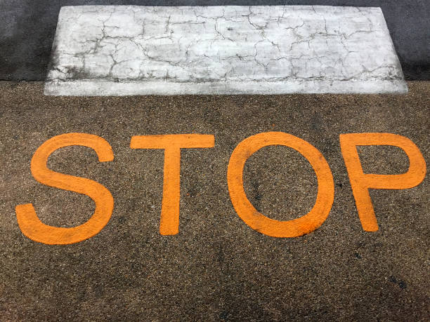istock Street Floor with STOP Text in front of Zebra Crossing 876474610
