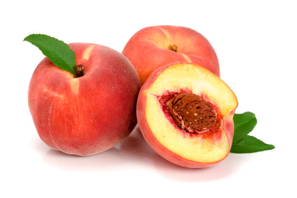 istock Peaches and half with green leaf isolated on white background 876474636
