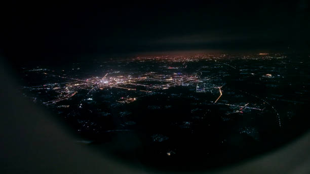 istock City night looking through airplane window 876478300