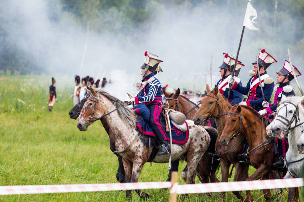 reenactment of the battle of borodino (the patriotic war of 1812 year). tourists watch the performance from from the fenced places. moscow region, russia. - history knight historical reenactment military imagens e fotografias de stock