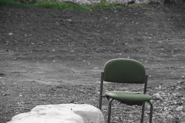 istock Chair in the middle of a field 876483336
