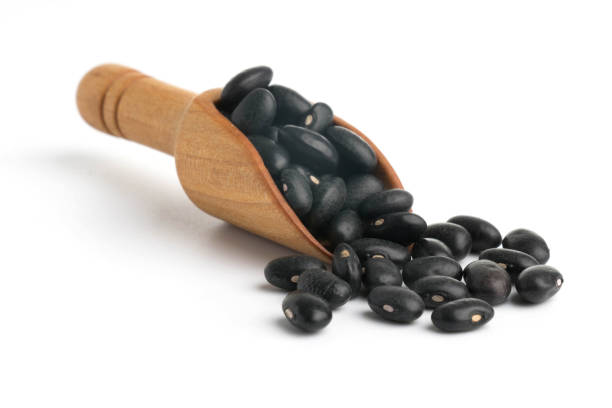 istock Black bean on spoon isolated  top view on a white background 876486330