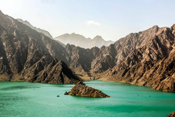 Lake between mountains at Hatta Dam eastern region of Dubai, United Arab Emirates stock photo