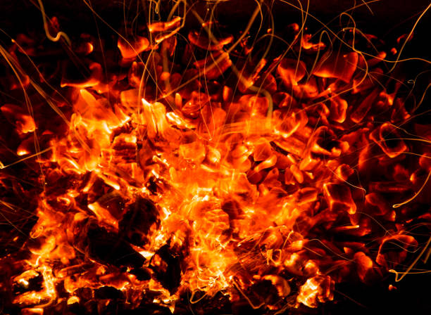 istock abstract background of burning coals of fire with sparks 876490042