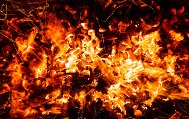 istock abstract background of burning coals of fire with sparks 876490474