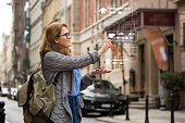 Augmented reality in marketing. Woman traveler with phone.