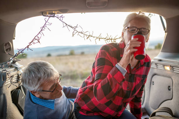 istock Senior couple outdoors with car 876493852