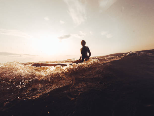 silhouette surfer mädchen - sea swimming greece women stock-fotos und bilder