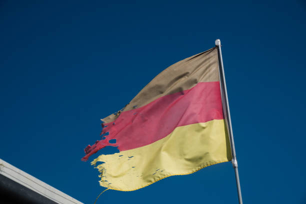 istock Torn flag of Germany fluttering 876498576