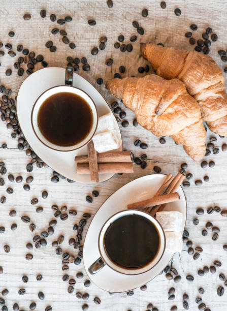 istock coffee grains with coffee cup and croissant 876503568
