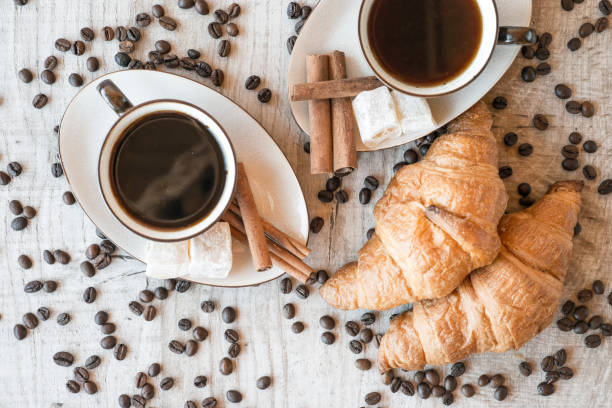 istock coffee grains with coffee cup and croissant 876503592