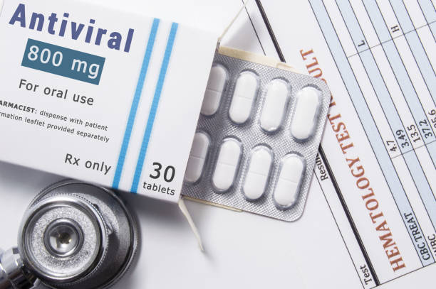 Antiviral drug. Open paper packaging box of medication with name group of drug Antiviral, blister with pills, next to stethoscope and blood test results. Concept for treatment of virus diseases Antiviral drug. Open paper packaging box of medication with name group of drug Antiviral, blister with pills, next to stethoscope and blood test results. Concept for treatment of virus diseases antiviral drug stock pictures, royalty-free photos & images