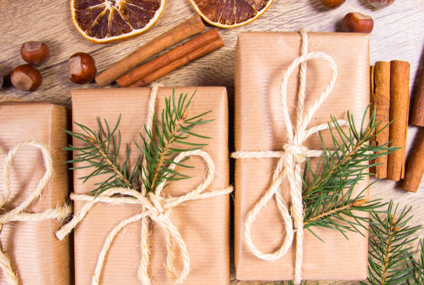 istock Christmas gifts in rustic boxes on wooden background. 876505374