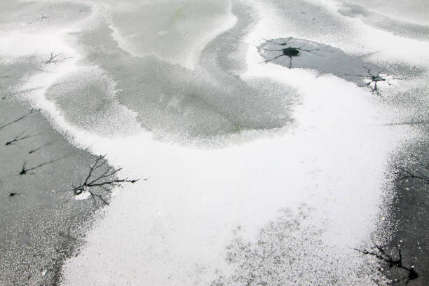 istock cracked ice on river in winter, China 876507522