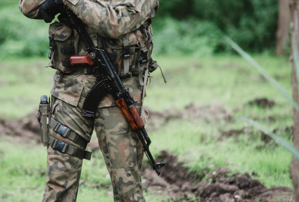 istock close up on soldier with machine gun 876508722