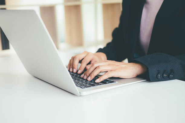 istock female hands typing on the notebook keyboard.Concept of young people work mobile devices. 876509216