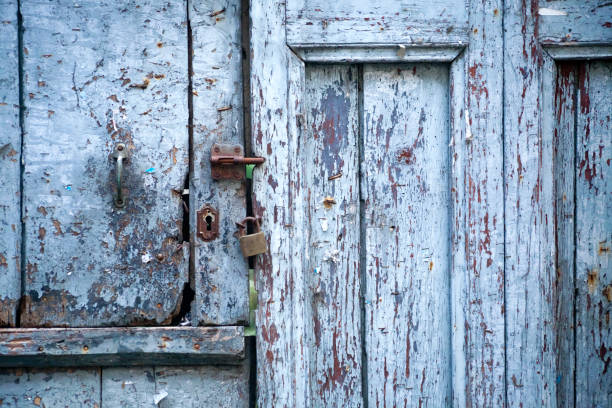 istock Old wooden blue door with lock and latch. 876511698