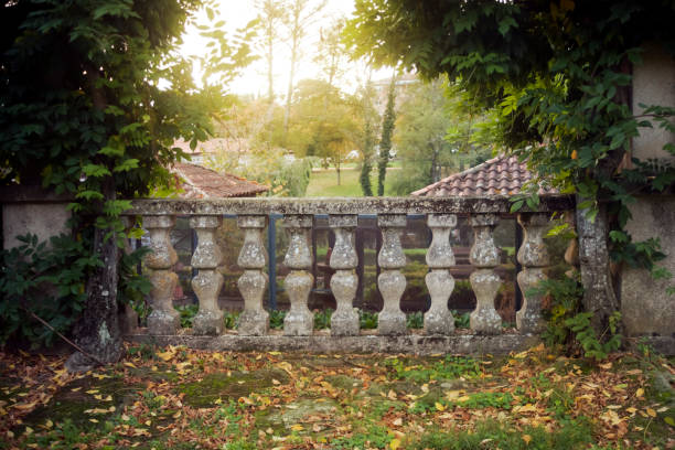 Old stone baluster back lit at dusk, architectural feature in Allariz garden, Ourense province,  Galicia, Spain.