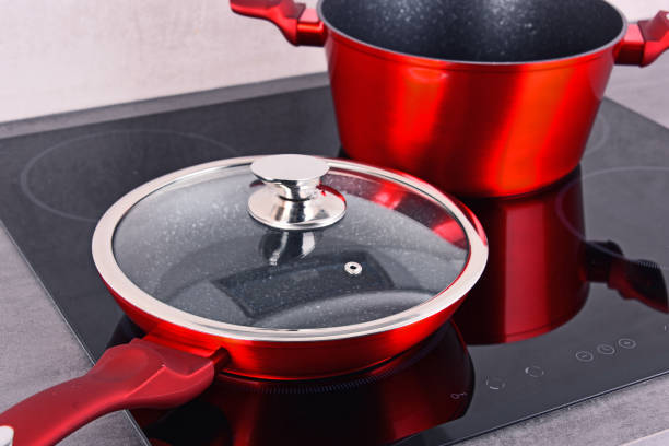 istock Frying pan and steel pot on modern induction cooktop 876512970