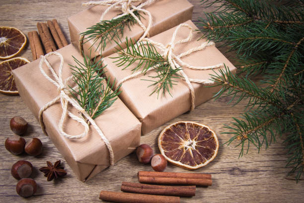 istock Christmas gifts in rustic boxes on wooden background. 876515776