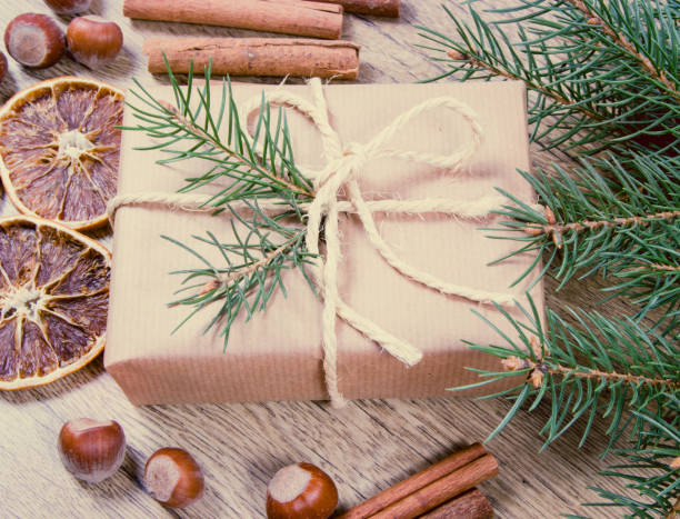 istock Christmas gifts in rustic boxes on wooden background. 876521740
