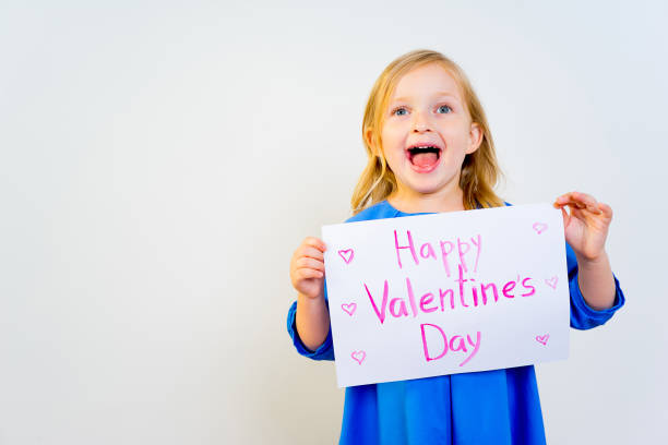 istock Girl with valentine postcard 876522100
