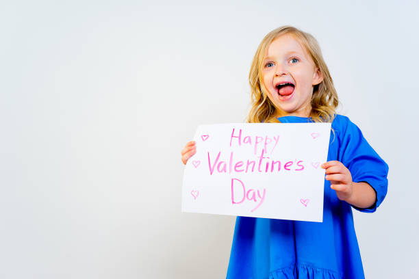 istock Girl with valentine postcard 876522204