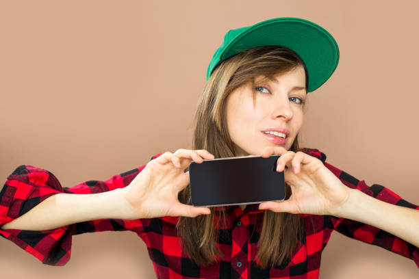 istock Young woman holding smartphone 876522448