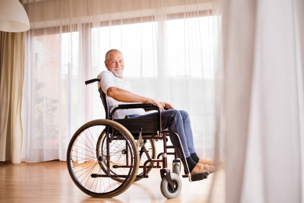 istock Senior man sitting on wheelchair at home. 876523668