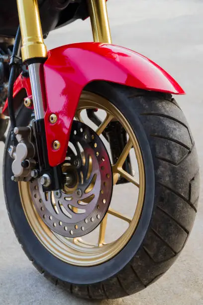 Motorcycle wheels parked in a road.