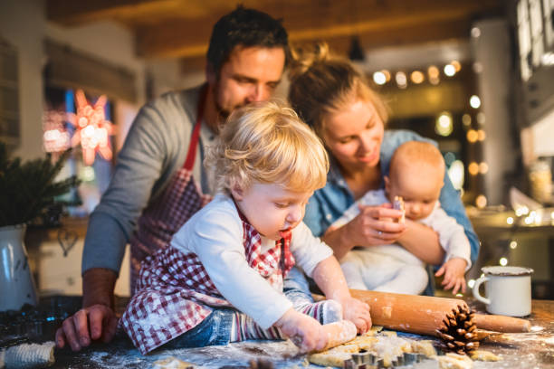 istock Young family making cookies at home. 876523864