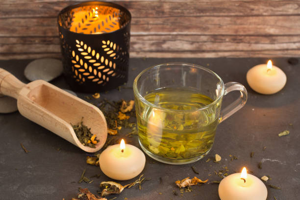 istock tea with candles and wood background 876523944