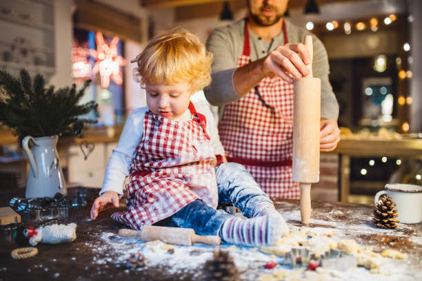istock Young family making cookies at home. 876523978