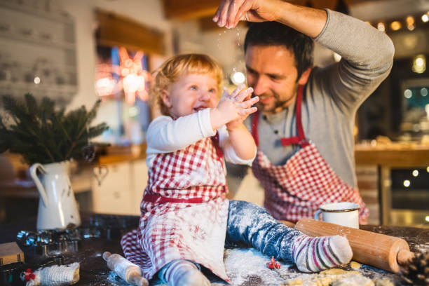 istock Young family making cookies at home. 876524114