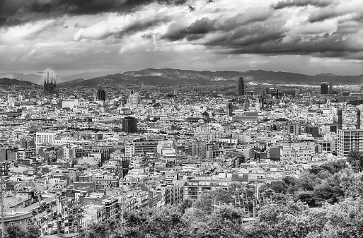 Barcelona panoramic cityscape at sunset. The mountains are visible in the background. High angle view.
