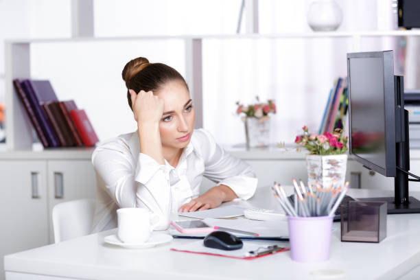istock tired woman manager in the office 876538810