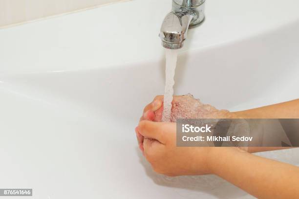 Washing Of Hands With Soap Under The Crane With Water Stock Photo - Download Image Now