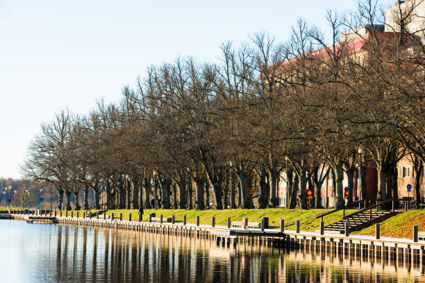 Vaxjo: Documentary of everyday life and environment. Lakeside promenade on sunny fall morning with a thin layer of hoarfrost on the walkway.