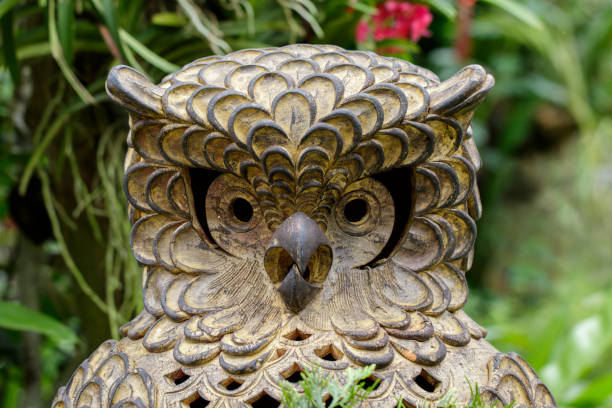 istock Statue of an owls on nature background. Art 876545944