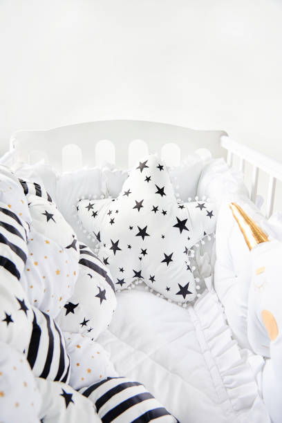istock Cozy baby cot with star shaped cushion and patchwork comforter blanket with stars and black stripes 876550636
