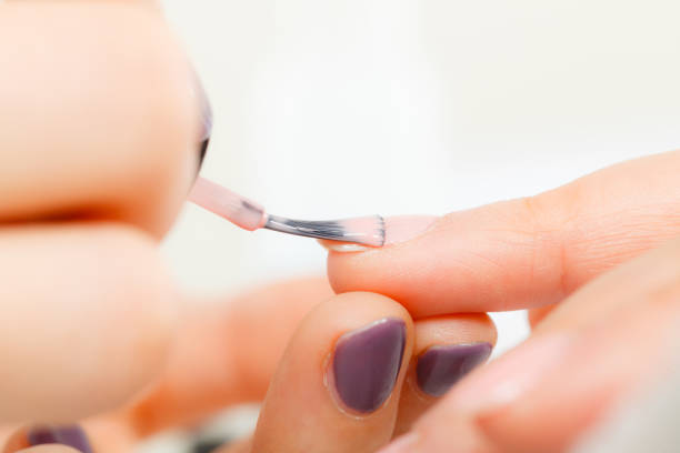 istock Woman in beauty salon getting manicure done. 876551194