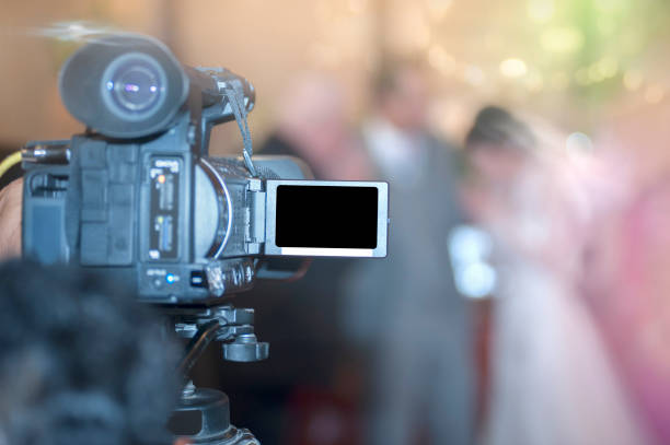 istock shooting bride and groom with video camera in wedding ceremony, focus at camera. 876551208