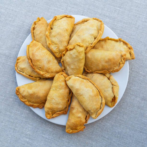 istock Fresh, crispy, puff pies on a white plate. View from above 876555030